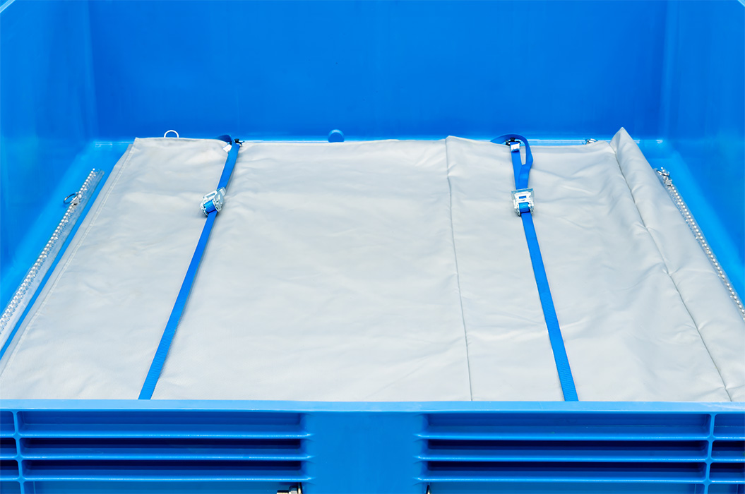 Eine blaue Kunststoffkiste mit grauem Planenboden und blauen Riemen.